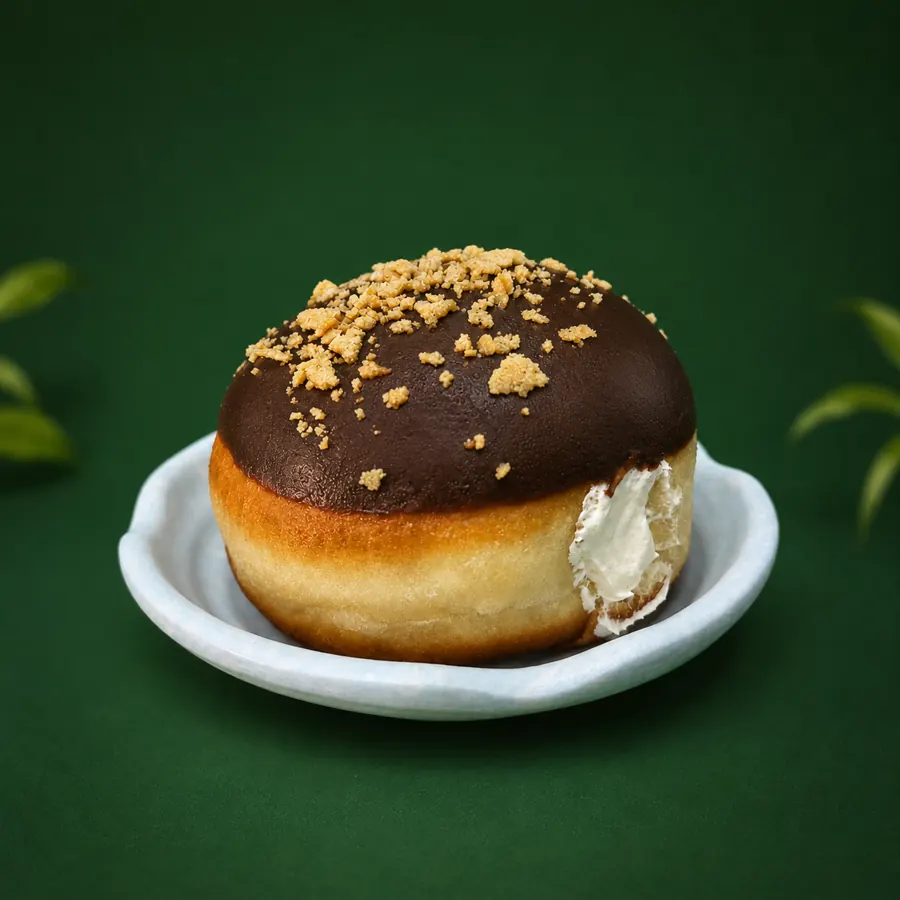 Chocolate-glazed berliner with a custard filling